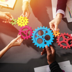 Teamwork of businesspeople work together and combine pieces of gears. Partnership and integration concept