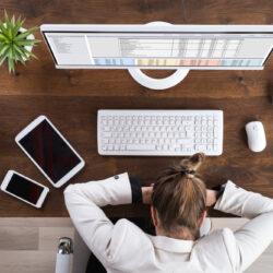 Young,Businesswoman,Sleeping,On,Desk,At,Workplace